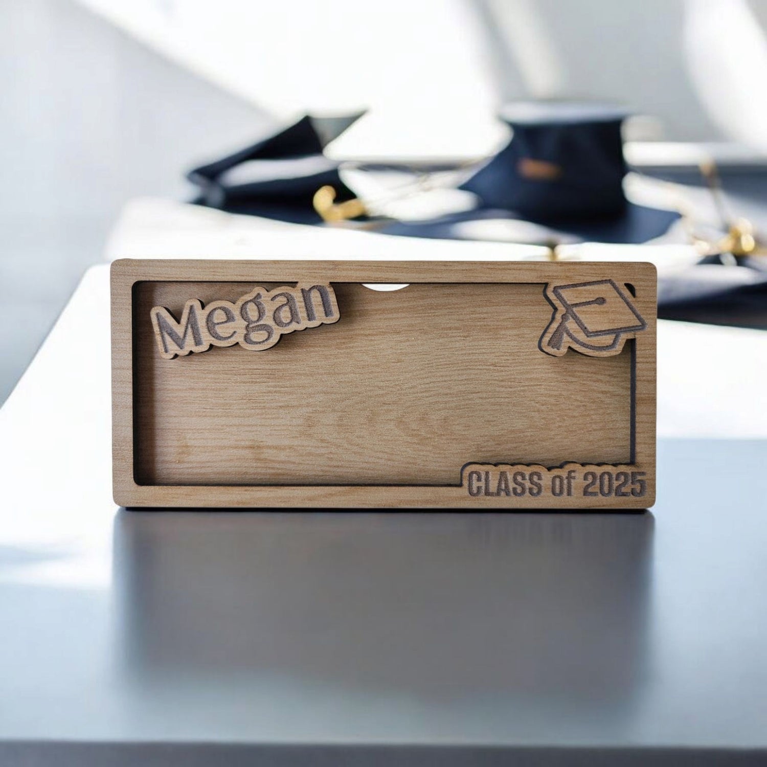 A unique graduation gift from Mirabilia Boutique, this personalized wood money holder is engraved with "Megan" and "Class of 2025," plus a graduation cap design. It’s the perfect custom cash card for any grad!.