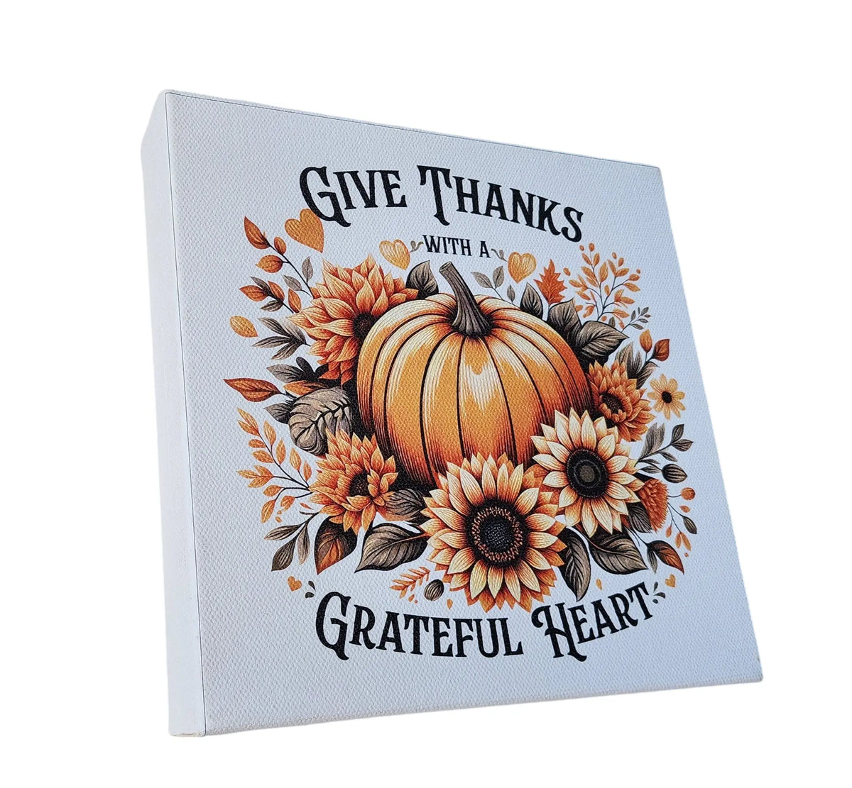 The Mirabilia Boutique "Give Thanks With a Grateful Heart" 8x8 wood sign features a pumpkin with sunflowers—ideal Thanksgiving décor to add rustic autumn charm and gratitude to your home.