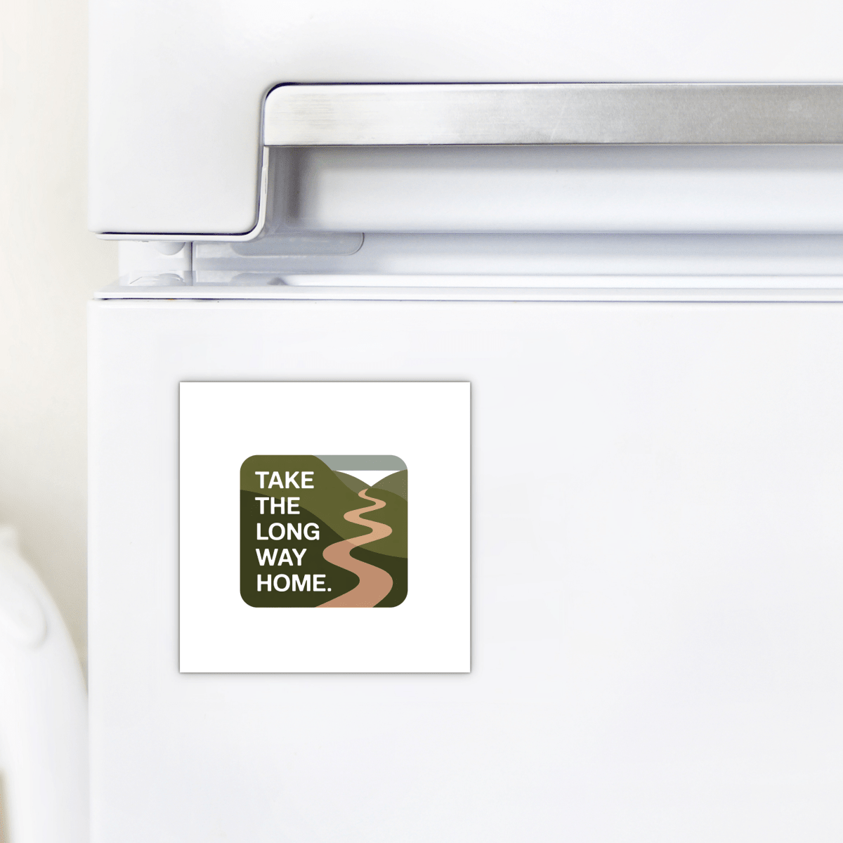 The Mirabilia Boutique Take the Long Way Home Travel Magnet is a square, nature-inspired accent featuring a winding road through green hills and the quote "TAKE THE LONG WAY HOME"—perfect for decorating your fridge.