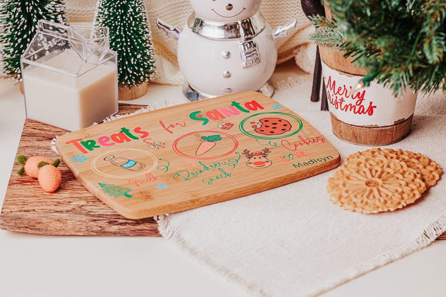 Create a festive Christmas Eve tradition with the Personalized Santa Treat Tray by Mirabilia Boutique—a custom bamboo board labeled for cookies, milk, and a carrot, perfect for setting out Santa’s treats beside your favorite holiday décor.
