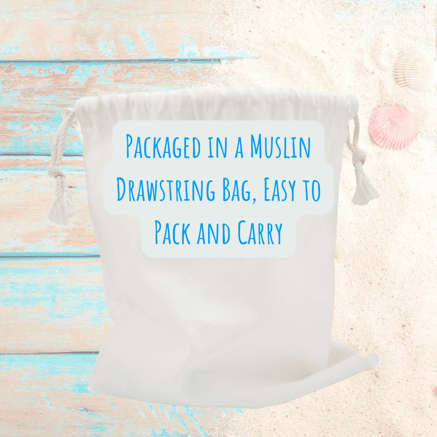 A white muslin drawstring bag with blue text sits on a beach backdrop—perfect for storing your Mirabilia Boutique Beach Match Game | 60 Tiles | Screen-Free Family Fun or other memory-boosting games.
