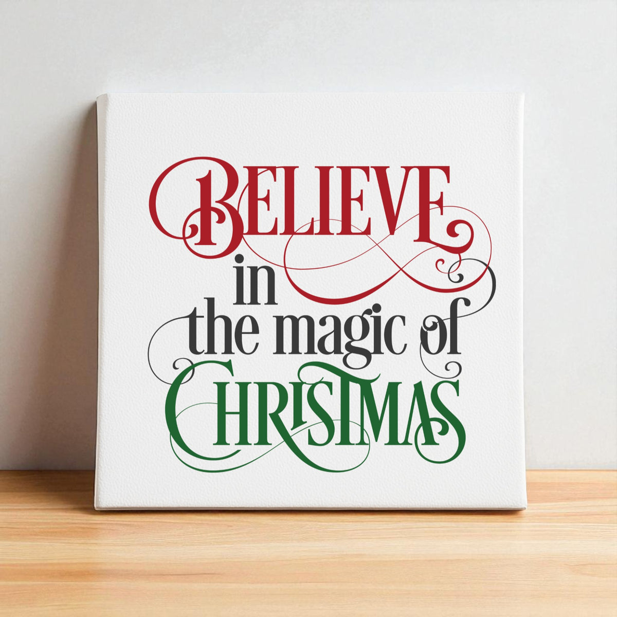 The "Believe in the Magic of Christmas Wall Art" by Mirabilia Boutique features festive red and green lettering—charming canvas decor perfect for adding holiday spirit to your home.