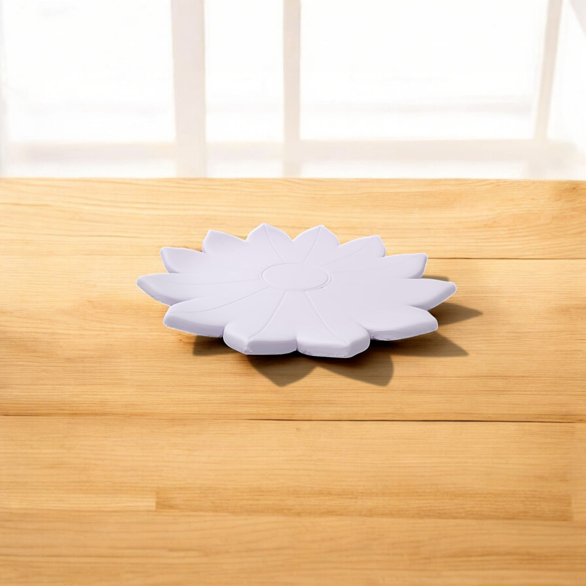 The Spring Bloom Tray by Mirabilia Boutique, a delicate floral accent in white, sits on a light wooden surface with sunlight streaming through a nearby window.
