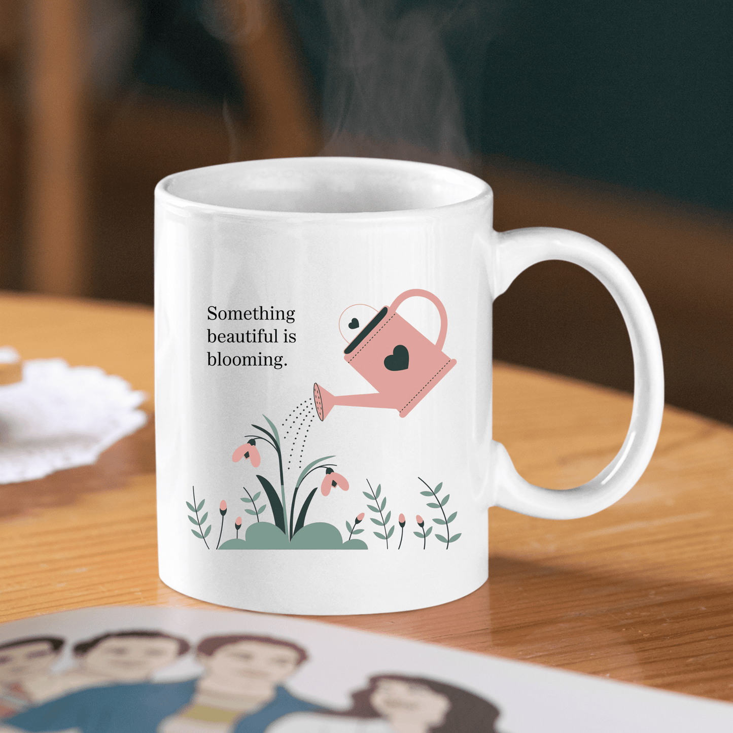 The Something Beautiful Is Blooming Mug by Mirabilia Boutique features a pink watering can and flowers with an inspiring quote—an uplifting gift for growth and positivity.