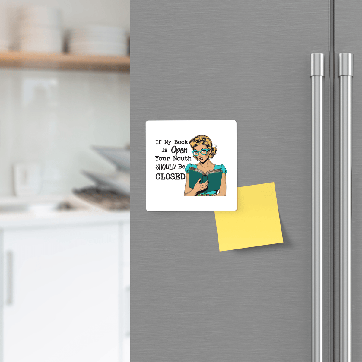 The Book Lover Magnet by Mirabilia Boutique is a 3x3 retro-style magnet reading "If my book is open, your mouth should be CLOSED." UV printed—makes a funny gift for readers and introverts.