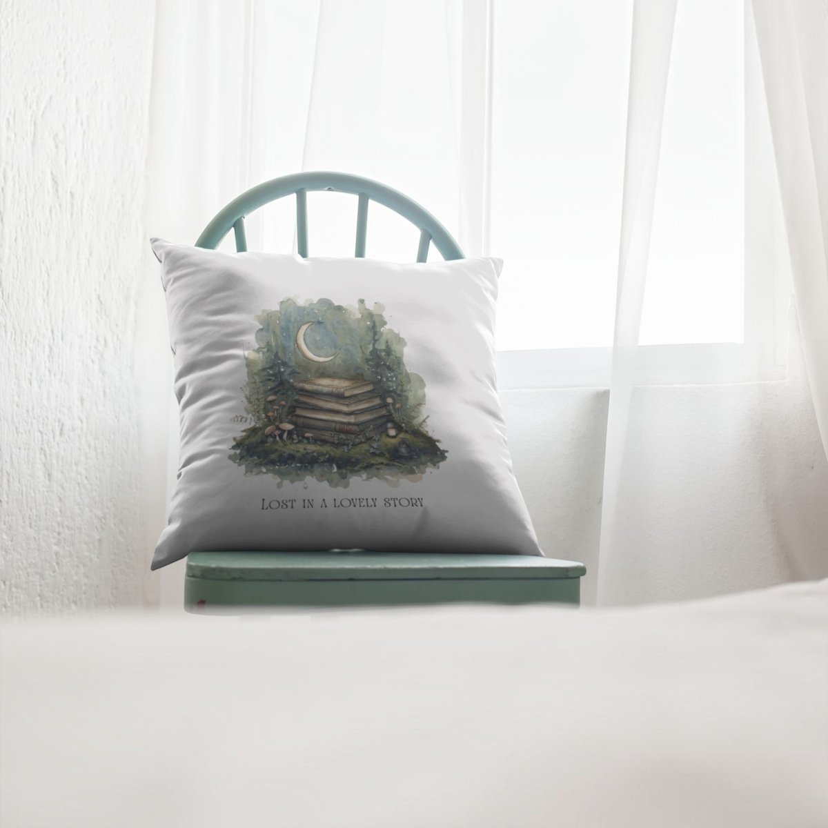 The Lost in a Lovely Story Throw Pillow from Mirabilia Boutique, adorned with a stack of books and crescent moon motif, rests on a green wooden chair by a sunlit window. Perfect for completing your cozy reading nook, this charming cottagecore décor piece is inscribed with: "LOST IN A LOVELY STORY.