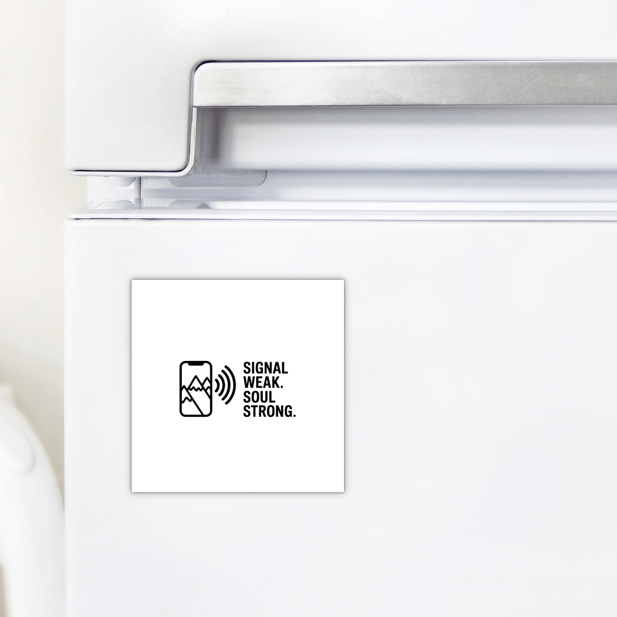 The Signal Weak Soul Strong Adventure Magnet by Mirabilia Boutique features a mountain design, a phone with a weak signal icon, and the phrase "Signal weak. Soul strong." in black on white—perfect for your white fridge.