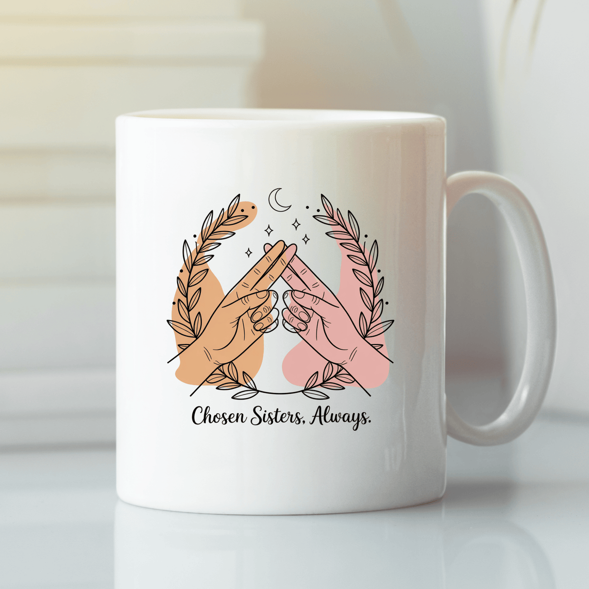 The Best Friend Mug by Mirabilia Boutique features two hands making a pinky promise, leafy branches, stars, and a crescent moon, with "Chosen Sisters, Always"—a perfect Galentine’s gift for your best friend.