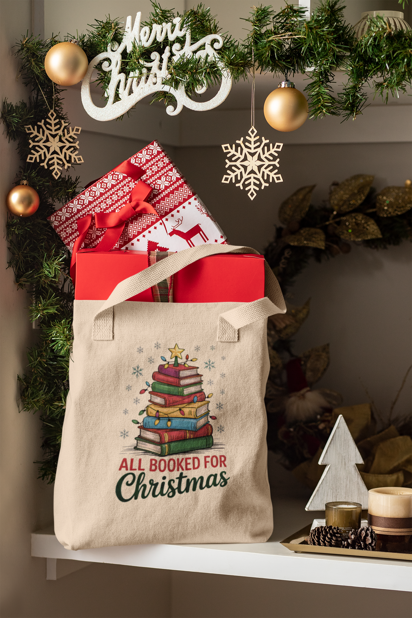 A festive scene with the Mirabilia Boutique "All Booked for Christmas Book Stack Tote Bag," perfect for book lovers, holding wrapped gifts among ornaments and a "Merry Christmas" sign.