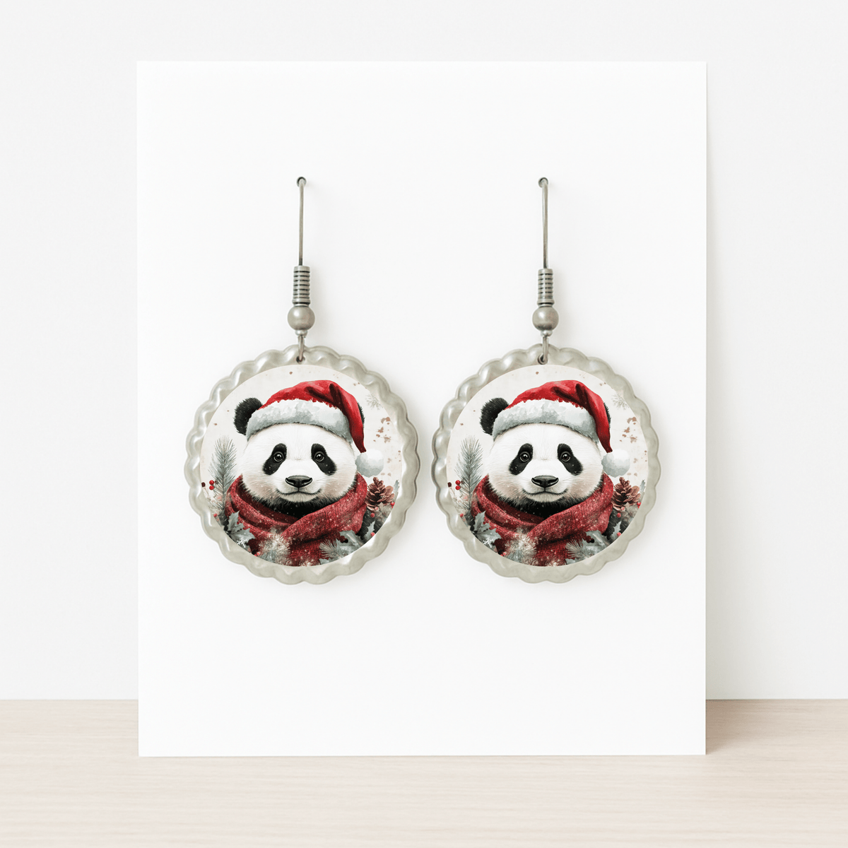 Christmas Panda Earrings by Mirabilia Boutique—cute holiday dangle jewelry with pandas in Santa hats and scarves. Displayed on a white card, they're festive, hypoallergenic, and perfect for sensitive ears.