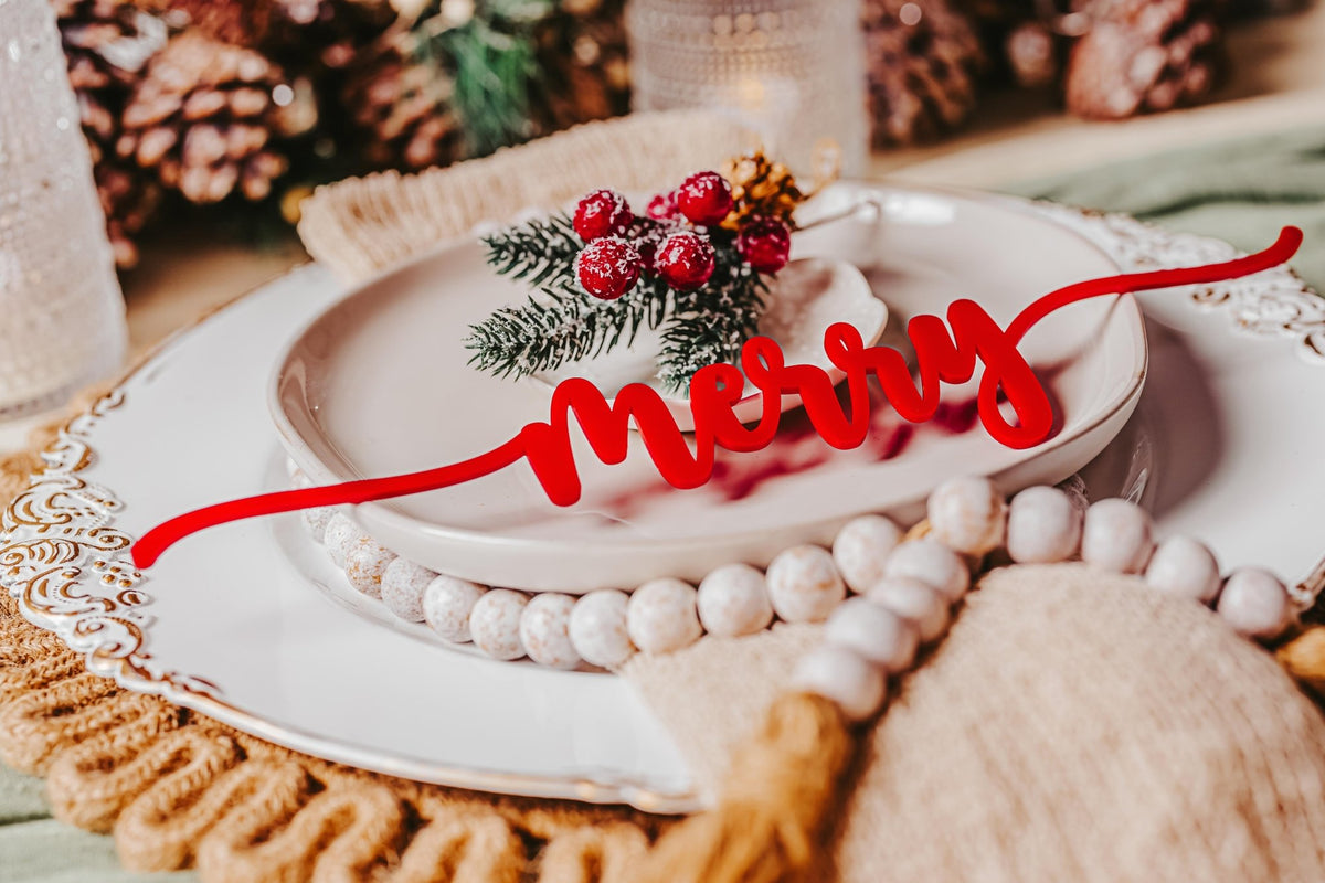 Create a joyful holiday table with the Mirabilia Boutique Red Acrylic Christmas Plate Words 8-Piece Set, featuring script accents. Complete the look with beaded napkin rings, pinecones, greenery, and red berries for festive cheer.