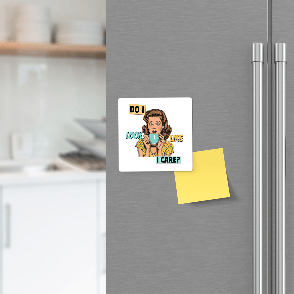 A refrigerator displays the Mirabilia Boutique "Do I Look Like I Care" funny retro 3x3 magnet—a sarcastic UV-printed gift for friends or coworkers. A yellow sticky note and a kitchen appear in the background.