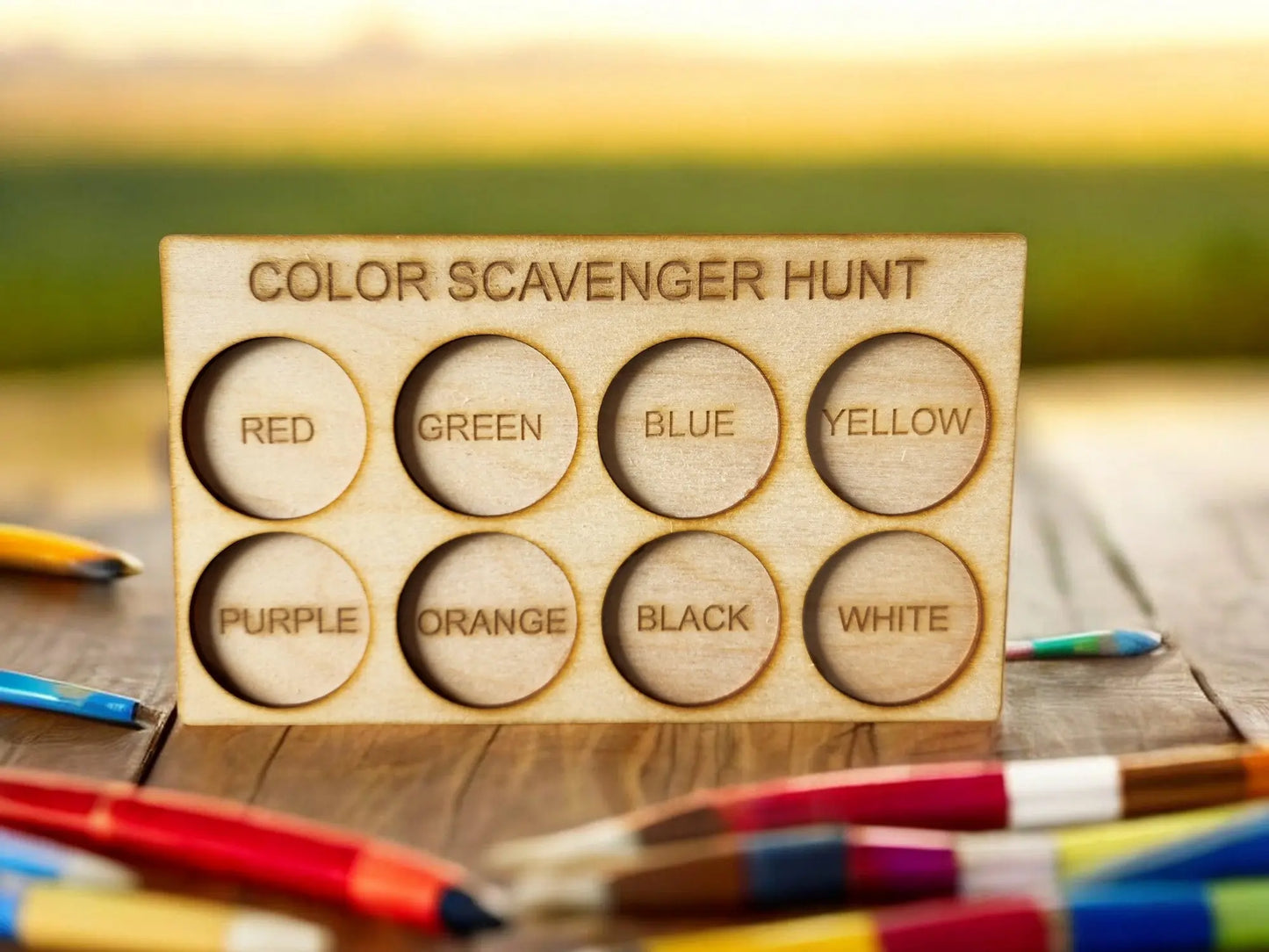 The Mirabilia Boutique Wooden Color Scavenger Hunt Board is a Montessori outdoor toy with eight labeled color circles, ideal for nature activities. This reusable, laser-engraved game encourages screen-free play for kids. Colored pencils can be used for added fun.