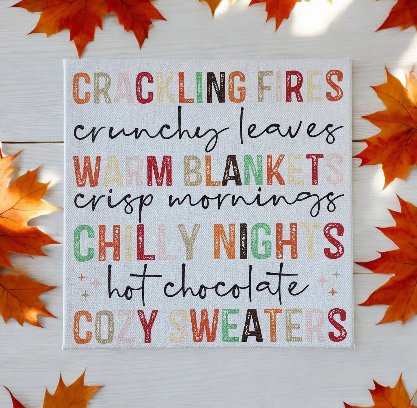 The Mirabilia Boutique Fall Words Canvas Sign features autumn-themed words on an 8x8 cradled wood canvas, UV printed and adorned with orange maple leaves for cozy seasonal wall art perfect for any space.