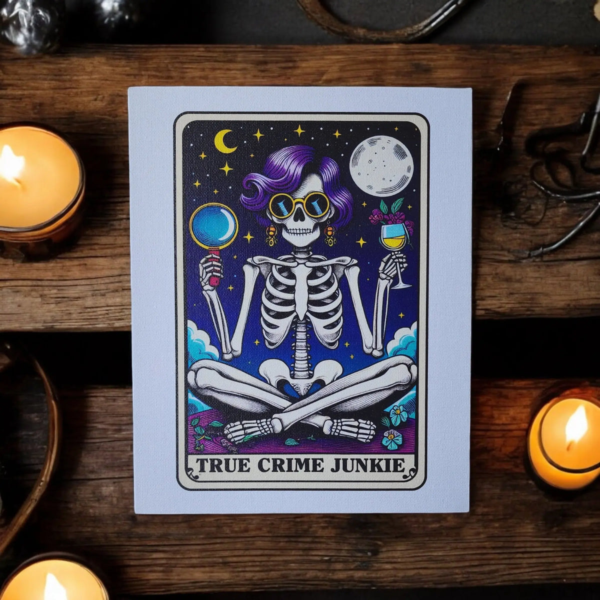 Mirabilia Boutique's "True Crime Junkie" Canvas Art features a vibrant skeleton with sunglasses, wine, and magnifying glass under the moon. This UV printed 8x10 décor is a fun gift for podcast lovers and true crime fans.