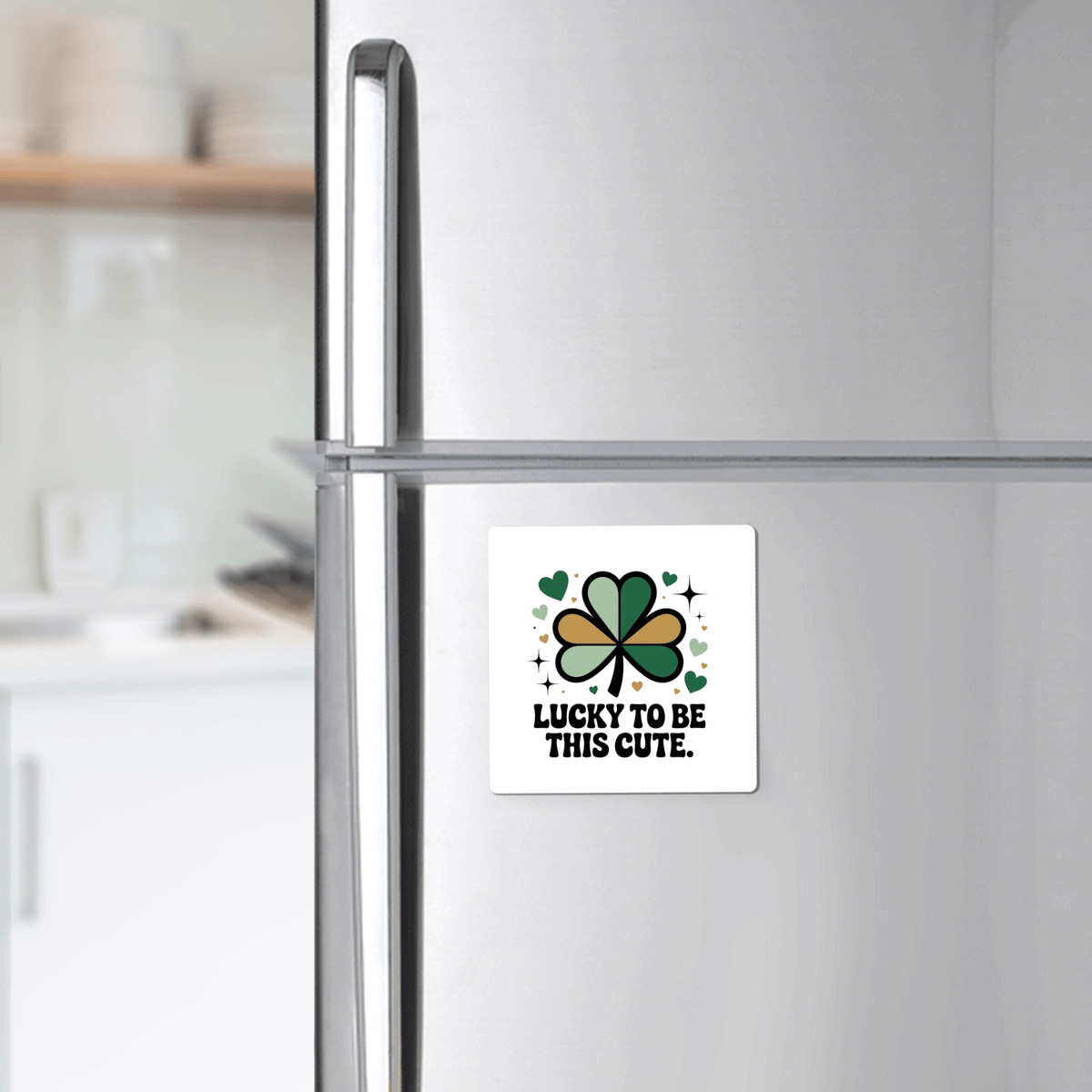 The Lucky to Be This Cute Magnet by Mirabilia Boutique features a shamrock, hearts, and sparkles with "Lucky to be this cute" text—a charming St. Patrick’s Day clover gift for any modern kitchen fridge.
