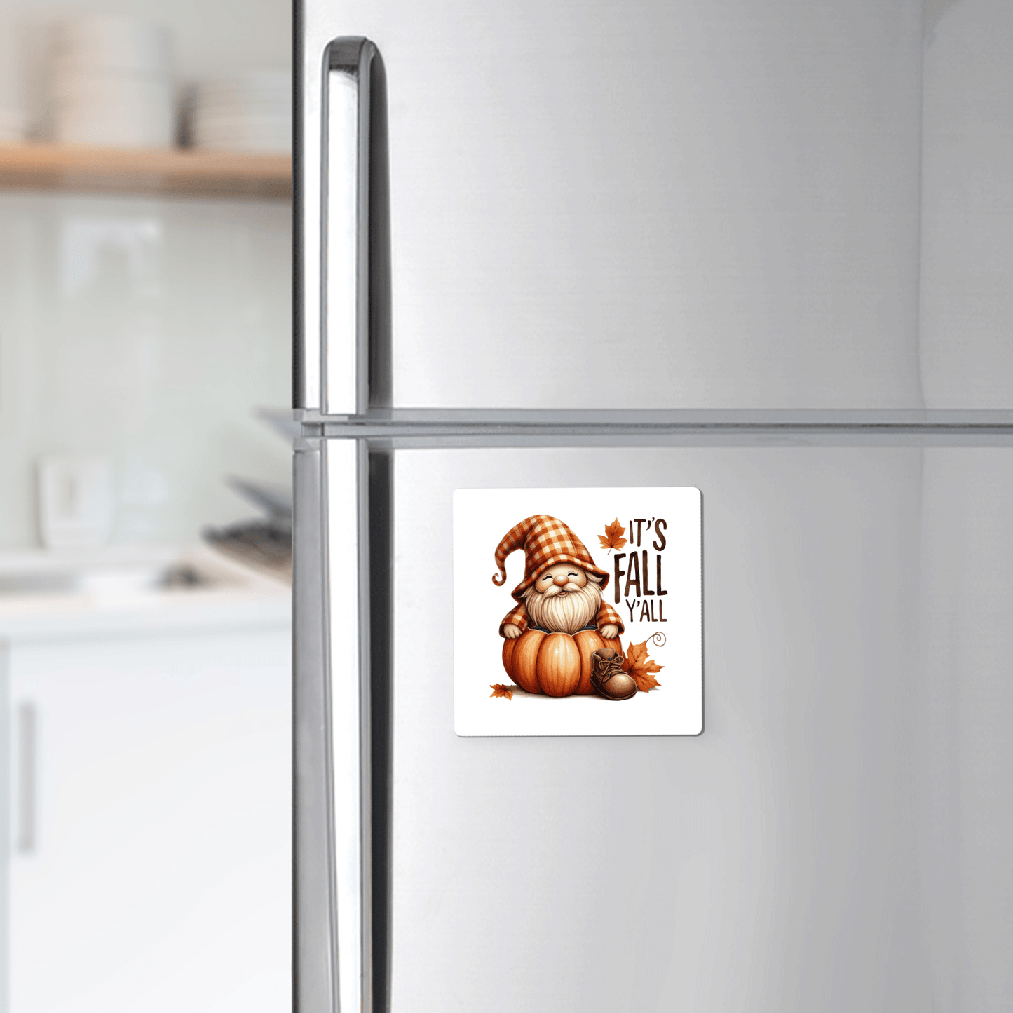 Add farmhouse charm to your kitchen with Mirabilia Boutique’s Fall Gnome Magnet—"It's Fall Y'all"—featuring a gnome in an orange plaid hat on pumpkins and autumn leaves. Perfect autumn fridge decor!.