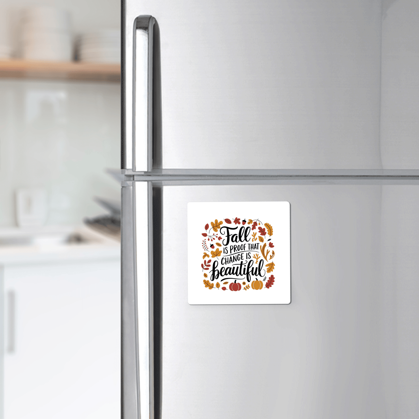 The Mirabilia Boutique Fall Is Proof Magnet features the quote "Fall is proof that change is beautiful" with autumn leaves and pumpkins, creating cozy, inspirational autumn kitchen decor.