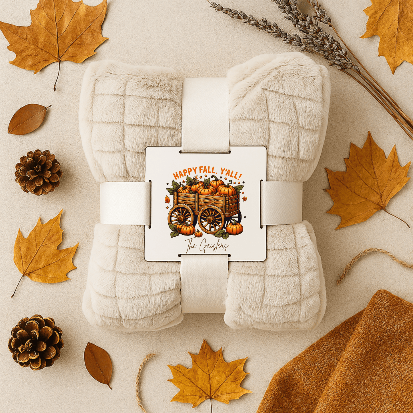 The Mirabilia Boutique Custom Fall Throw Blanket is a cream-colored cozy autumn gift, featuring a “Happy Fall, Y’all!” label with pumpkins and a wagon—perfect for home decor this season.