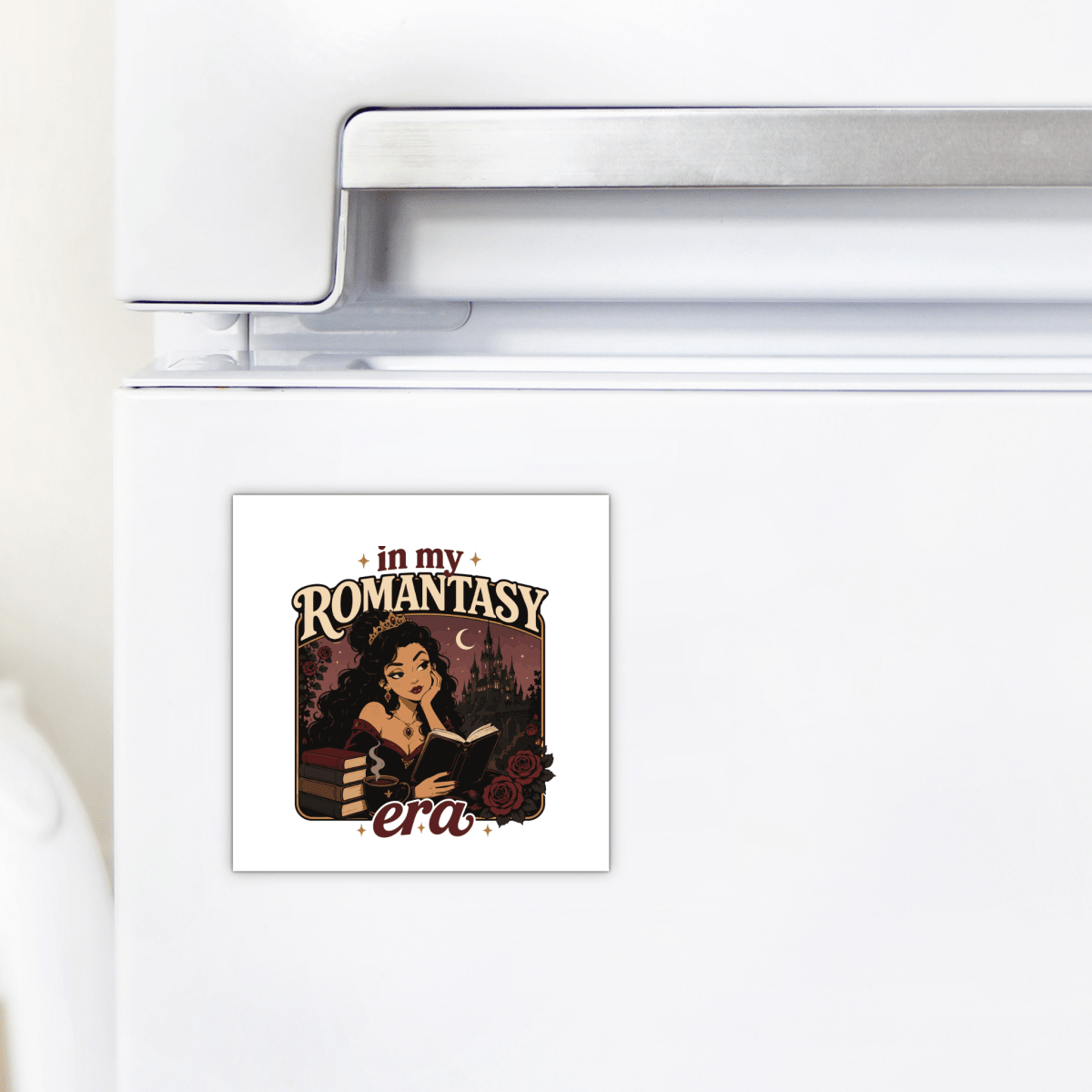 The "In My Romantasy Era Magnet" by Mirabilia Boutique is a square romantasy accessory featuring a woman reading among books and roses, with the phrase "in my ROMANTASY era" in stylized letters—a charming bookish decor piece that's perfect as a gift for fantasy readers.