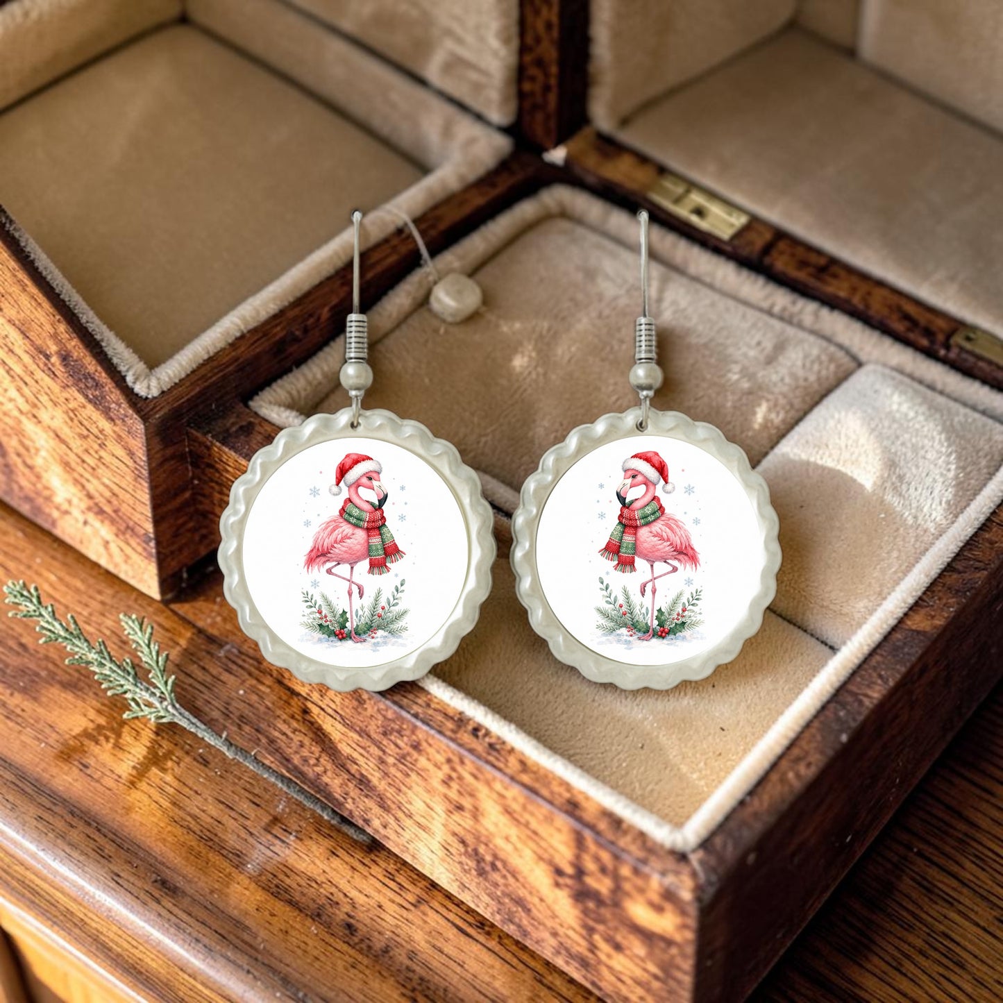 Nestled in a wooden jewelry box, the Festive Flamingo Earrings from Mirabilia Boutique showcase playful flamingos adorned with Santa hats and winter scarves, surrounded by holly leaves. These round, handcrafted beauties are the perfect piece of Winter Bird Jewelry to bring whimsical holiday cheer to your seasonal style.