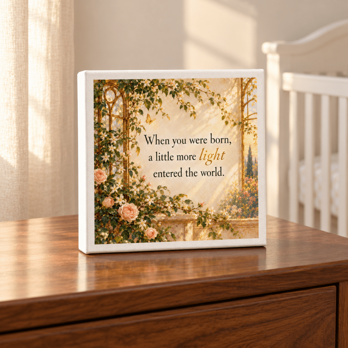 A Little More Light Canvas featuring a botanical wall decor illustration of a garden archway with climbing roses and the text, “When you were born, a little more light entered the world,” printed on a wooden surface.