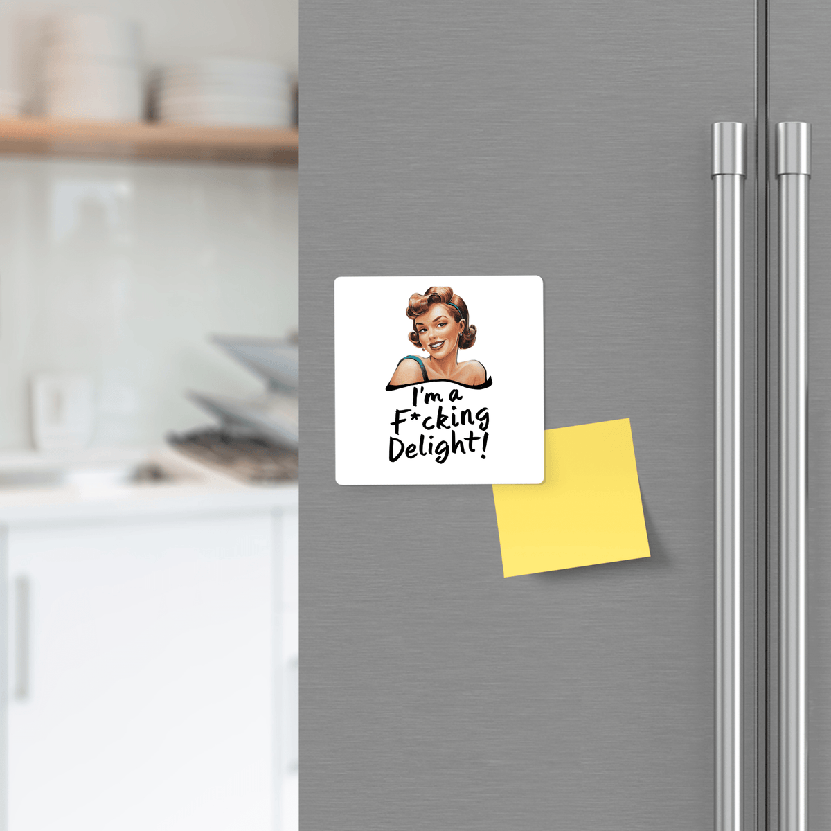 The Mirabilia Boutique “I’m a F*cking Delight” 3x3 retro magnet adds sassy charm to your fridge, shown beside a yellow sticky note with kitchen shelves in the background. Perfect funny gift for friends, coworkers, or yourself!.
