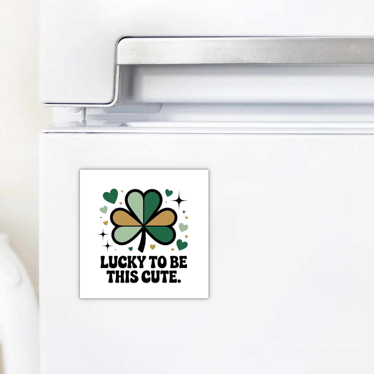 The Lucky to Be This Cute Magnet by Mirabilia Boutique is a square fridge magnet with a green and gold shamrock, hearts, and "Lucky to be this cute" text—an ideal St. Patrick's Day clover gift for any celebration.