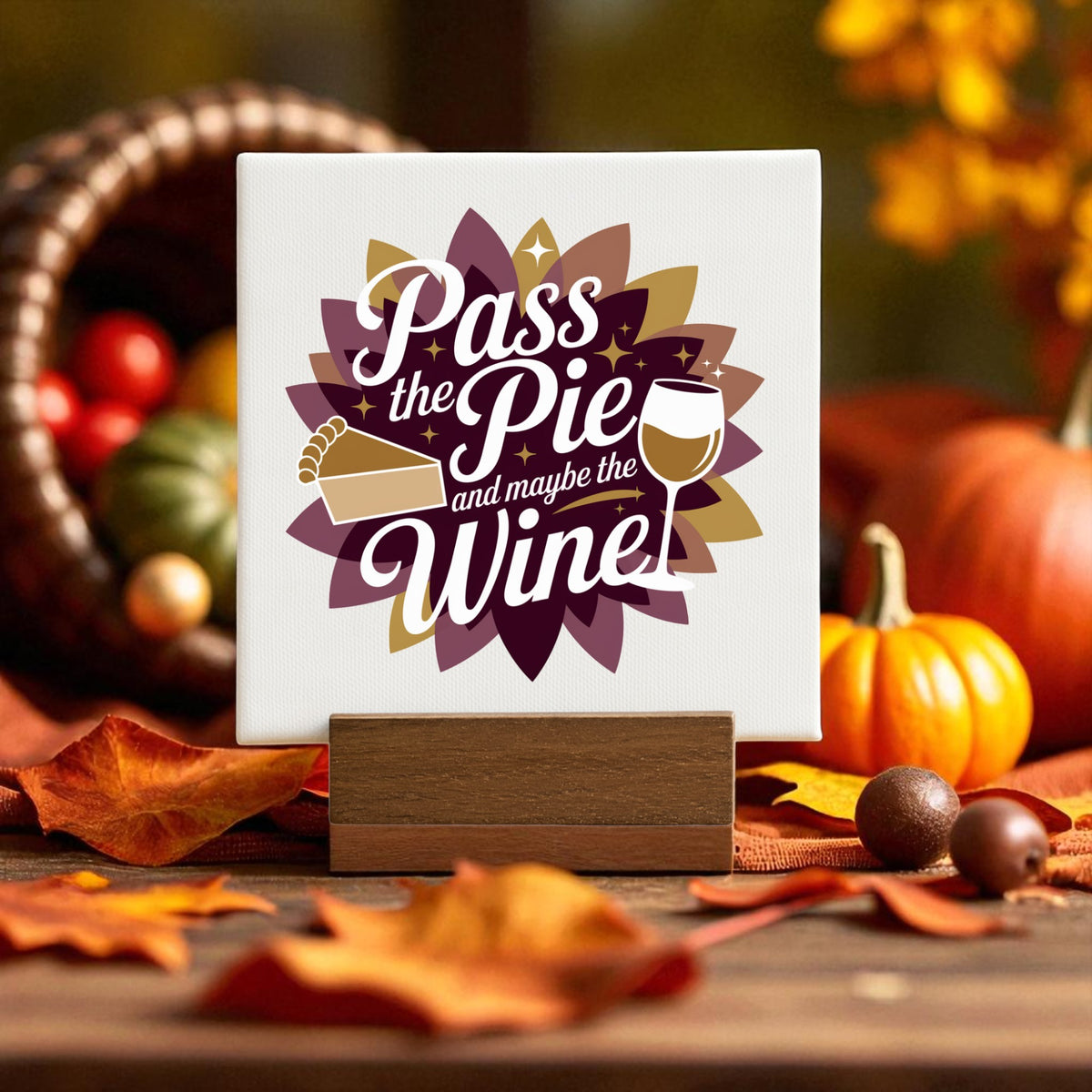 The Pass the Pie and Maybe the Wine Mini Fall Sign by Mirabilia Boutique features festive pie and wine art—ideal Thanksgiving decor or a fun fall gift for wine lovers, perfect for your autumn table.