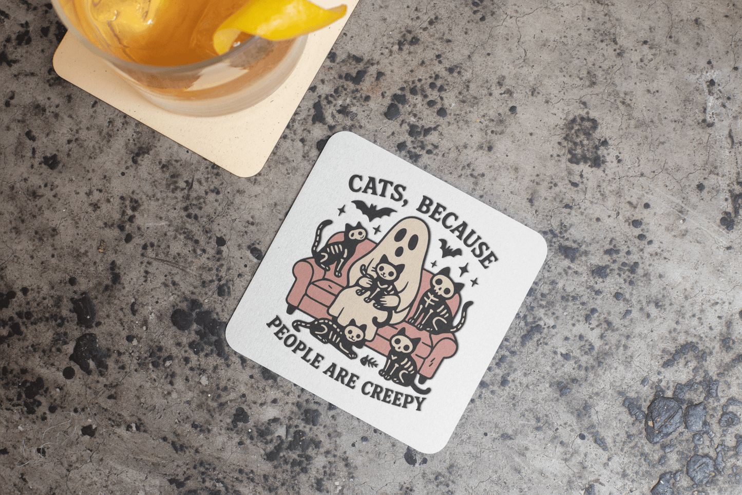 Mirabilia Boutique’s Funny Ghost Cat Coaster features cartoon cats and a ghost on a couch with the caption "Cats Because People Are Creepy." A quirky gothic home decor piece or cat lover gift—perfect for any drink.
