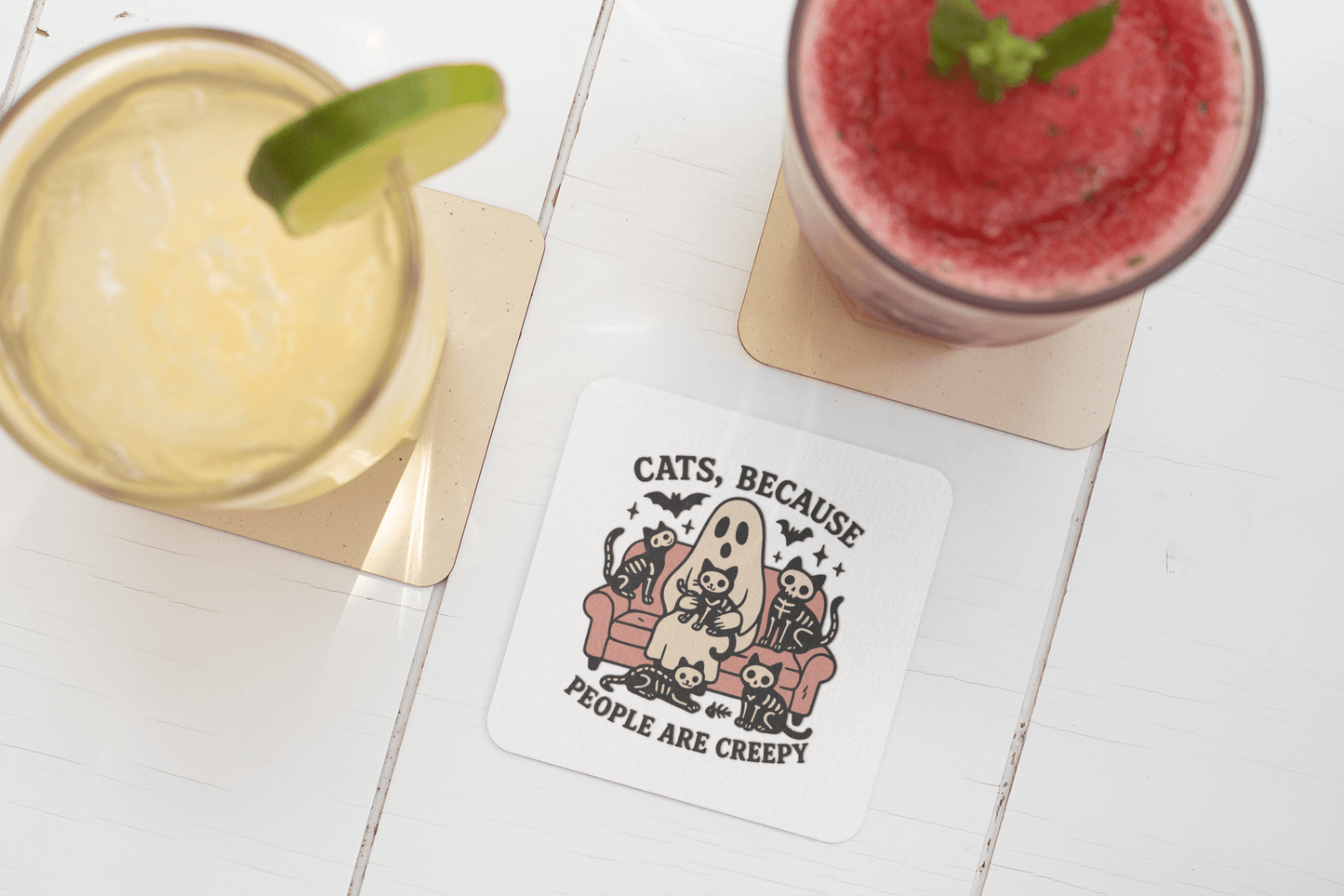 The Mirabilia Boutique Funny Ghost Cat Coaster features a cartoon person and cats on a couch with the text "Cats Because People Are Creepy," perfect for adding a quirky touch to your table.