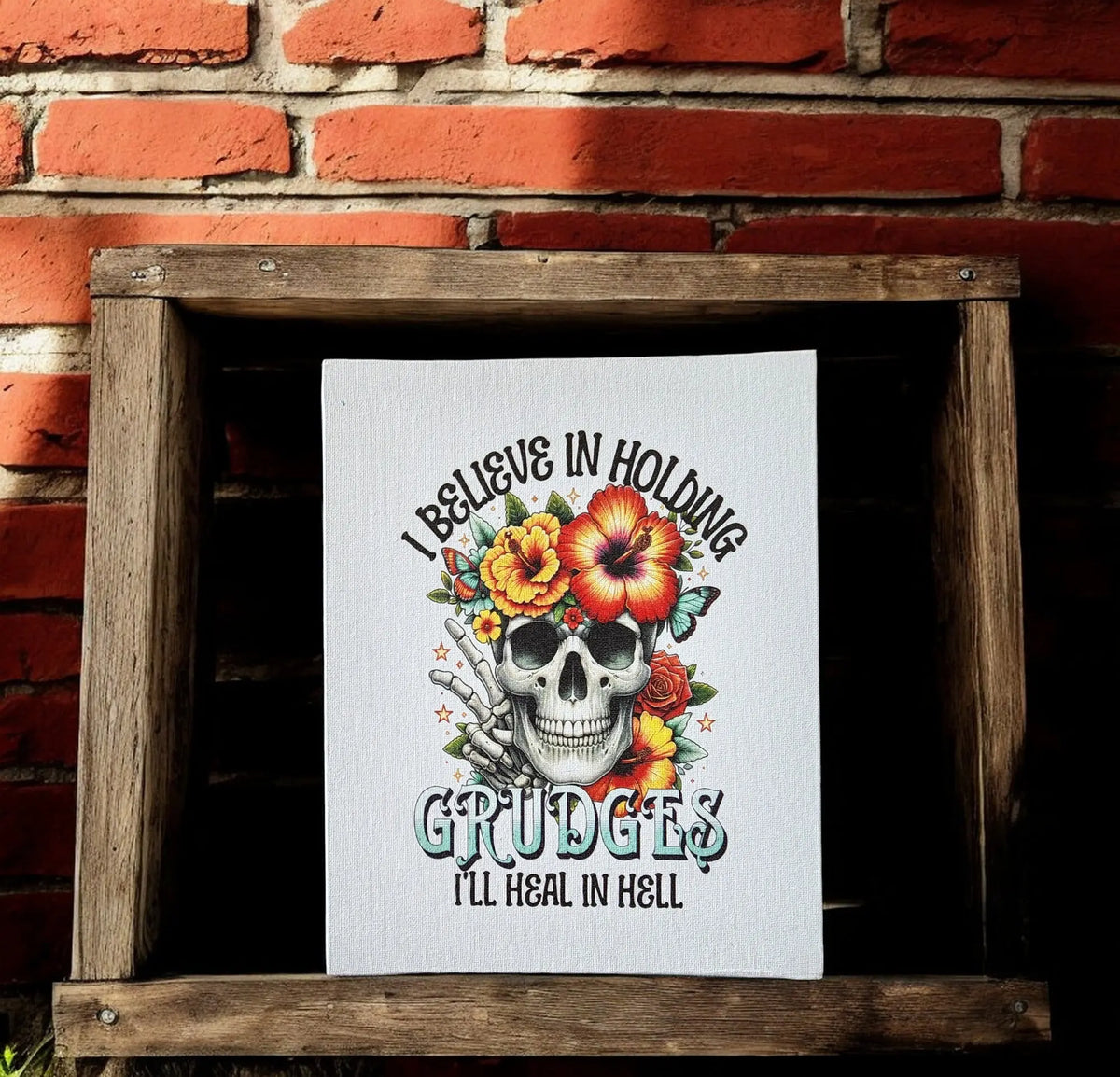 Mirabilia Boutique’s “I Believe in Holding Grudges” 8x10 canvas print features a skull with flowers and bold text—a striking dark humor wall art for gothic or edgy decor.