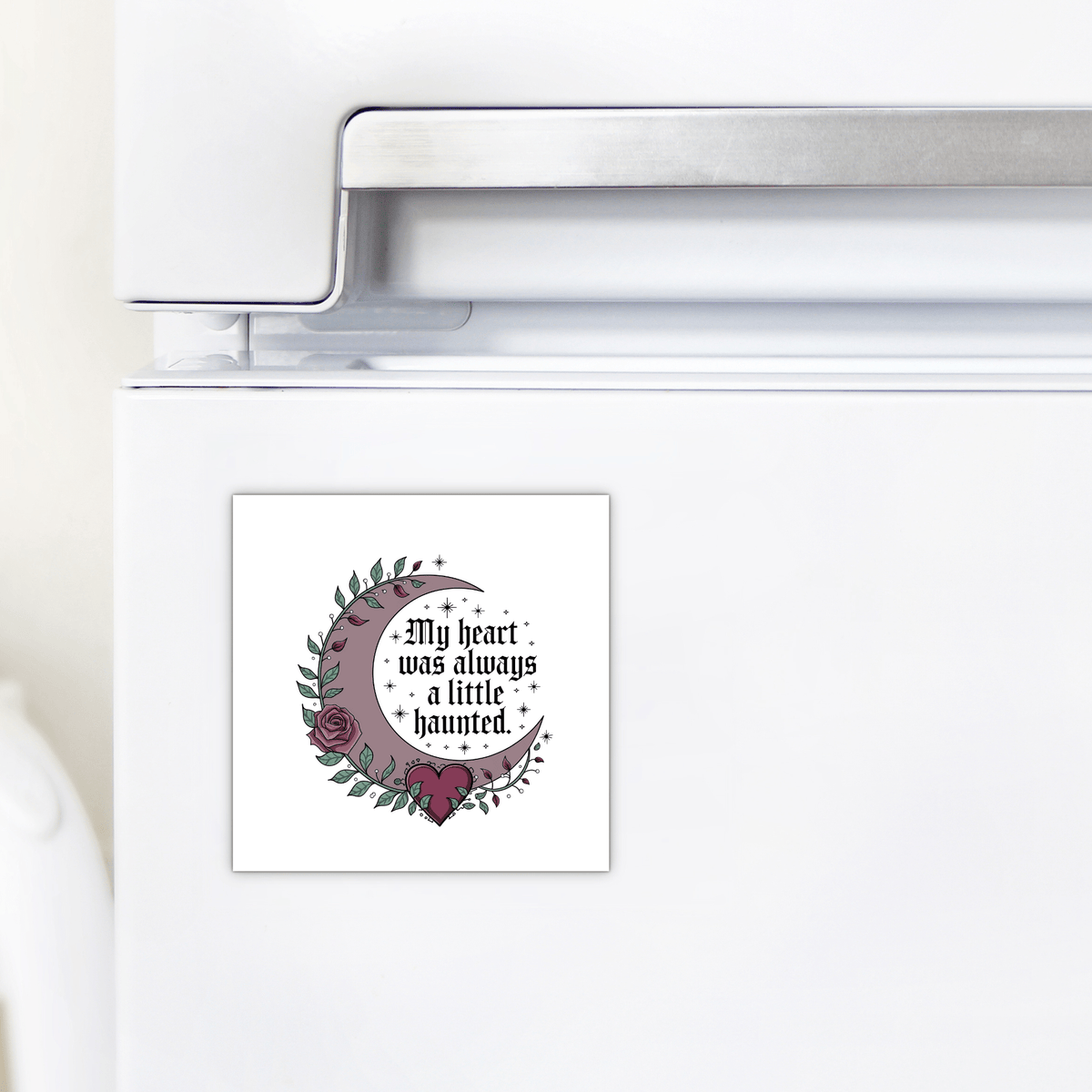 The Mirabilia Boutique Gothic Fridge Magnet features a haunted heart crescent moon design with roses and stars and the quote "My heart was always a little haunted"—the perfect gothic home decor accent.
