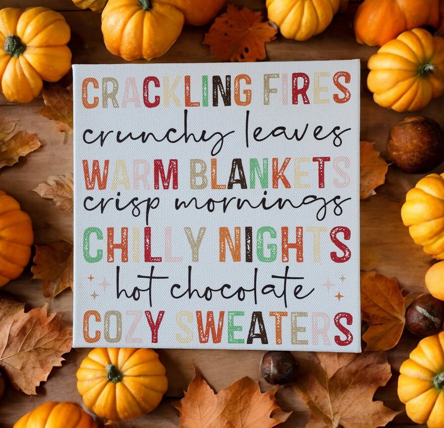 The Mirabilia Boutique Fall Words Canvas Sign (8x8 UV printed cradled wood) features festive autumn phrases—“Crackling fires, crunchy leaves, warm blankets…”—for cozy fall vibes. Perfect seasonal wall art for your home.