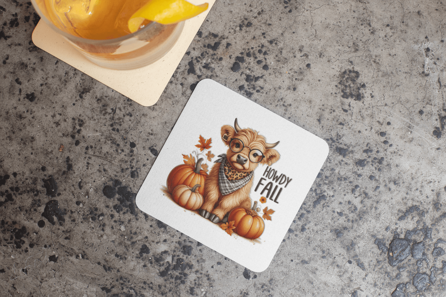 The Howdy Fall Highland Cow Coasters by Mirabilia Boutique feature a cute illustrated cow with glasses and a scarf, surrounded by pumpkins and autumn leaves—perfect rustic Western autumn decor for your home.