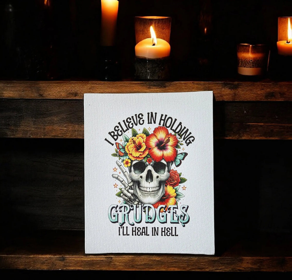 The Mirabilia Boutique "I Believe in Holding Grudges" Canvas Print features a skull and flowers with dark humor, perfect 8x10 wall art for bold spaces and striking Gothic decor.