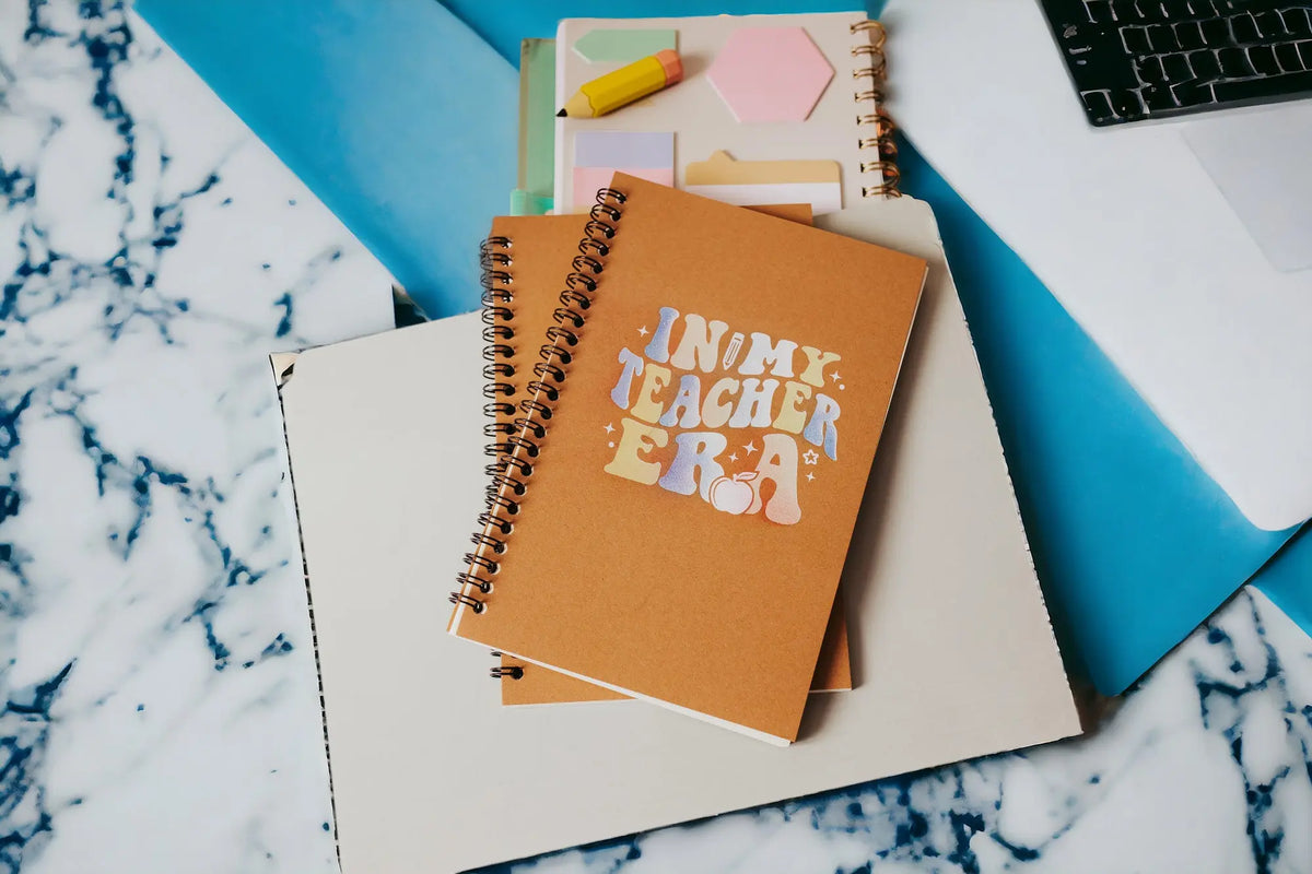 The Mirabilia Boutique "In My Teacher Era Notebook" is an aesthetic teacher spiral journal, perfect as a back-to-school or thoughtful teacher gift for any stylish educator.