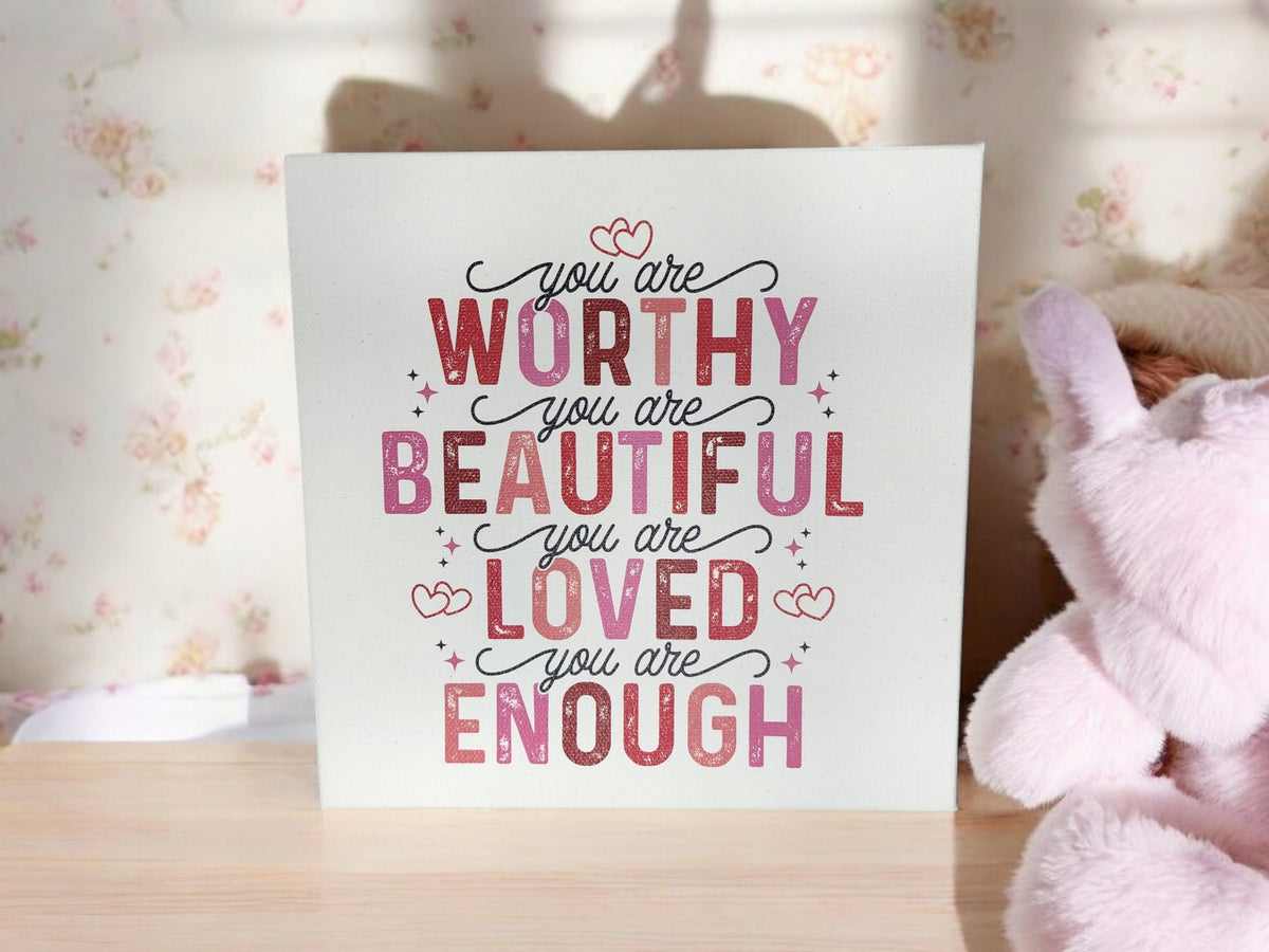 The Mirabilia Boutique "You Are Worthy Affirmation Sign" is an 8x8 canvas with pink and red positive messages—ideal inspirational wall art for women or teens. Display it as uplifting self-love decor or give it as a thoughtful gift.