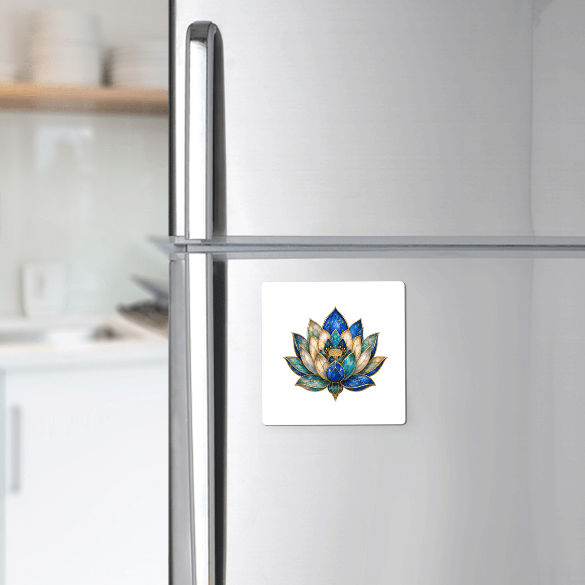 A refrigerator in a kitchen features the Lapis Bloom Magnet | Egyptian Lotus Art by Mirabilia Boutique on its door, adding a touch of botanical decor. White shelves with dishes are visible in the background.