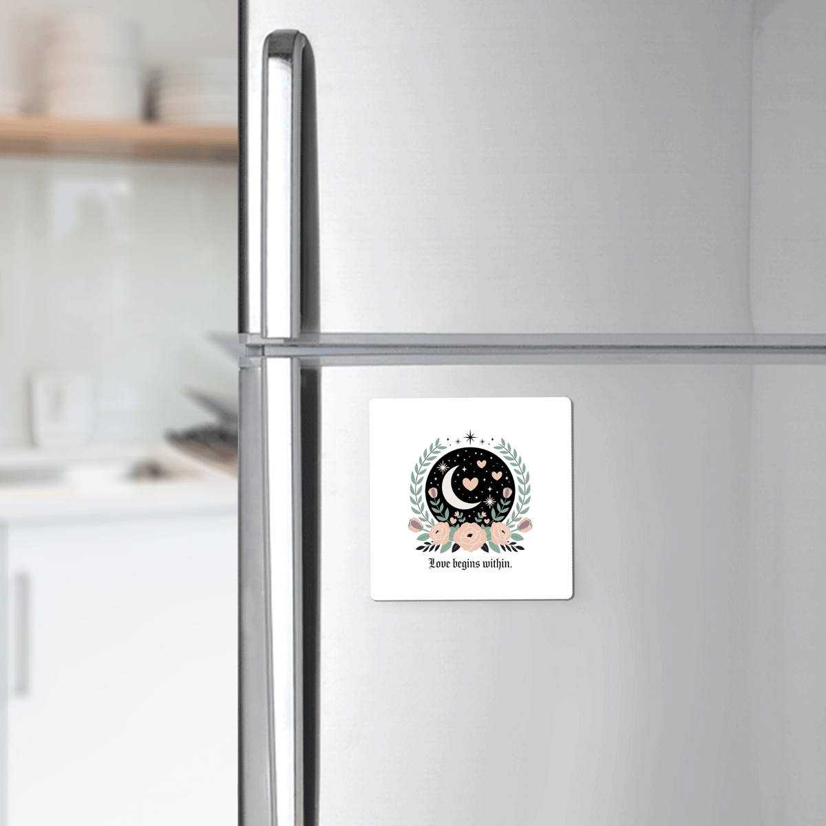 The Love Begins Within Magnet by Mirabilia Boutique, a square self-love gift with celestial and floral designs, adds inspiration to your fridge with its crescent moon, stars, and hearts, reminding you that love starts from within.