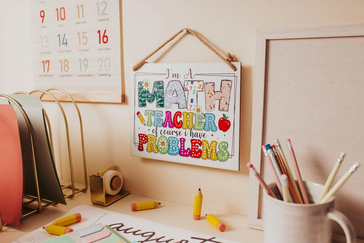 The Mirabilia Boutique Funny Math Teacher Classroom Sign—"I'm A Math Teacher Of Course I Have Problems"—makes a colorful, fun appreciation gift or decor for any educator.