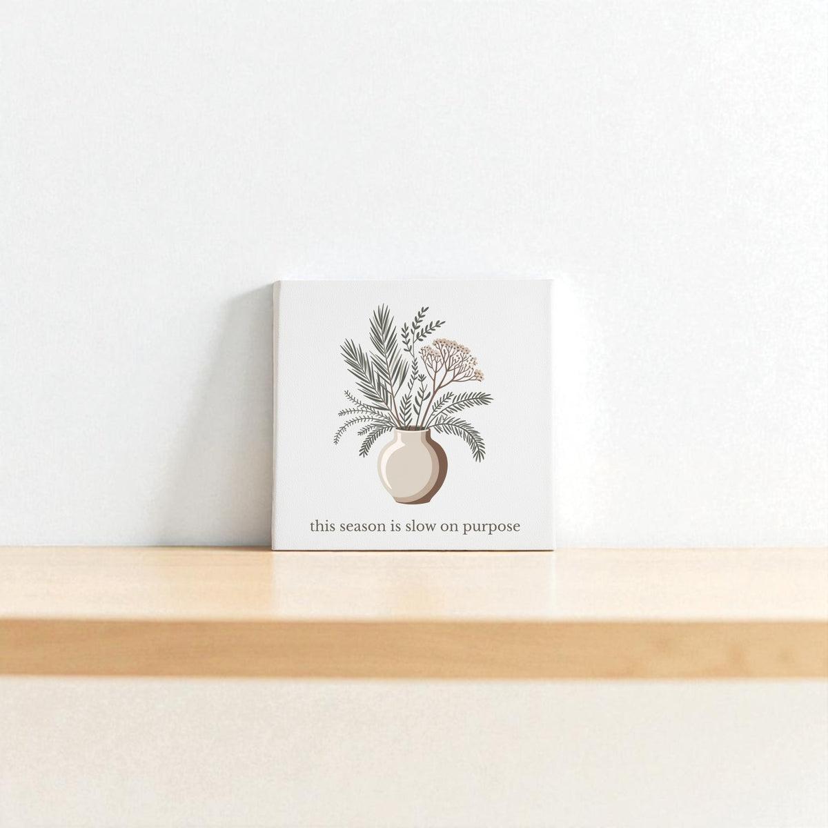 The “Slow on Purpose Canvas” by Mirabilia Boutique features a minimalist botanical vase design and inspiring quote, printed on plain white canvas—perfect wall art for those who value intentional living.