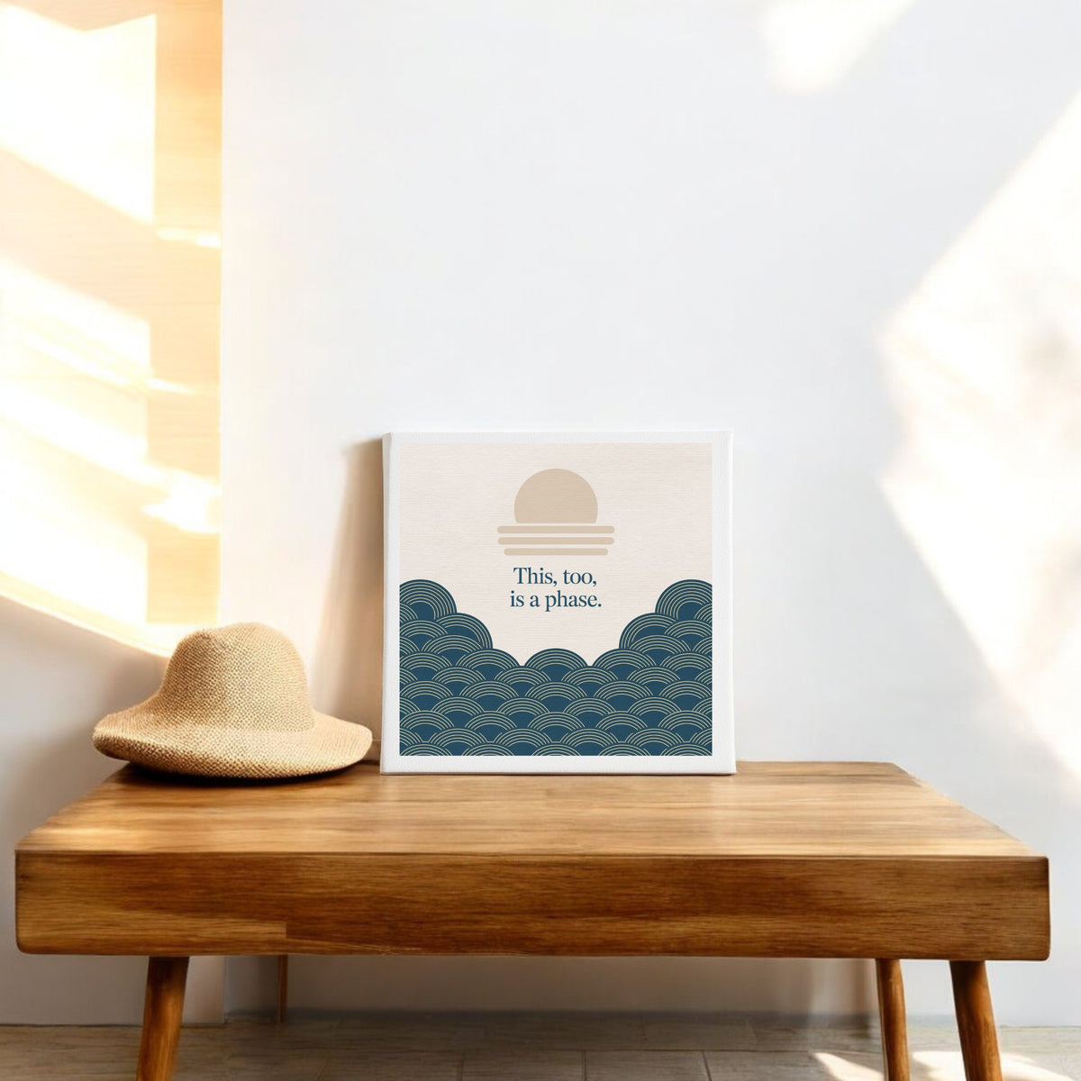 The "This Too Is a Phase Canvas – Calming Summer Wall Art" by Mirabilia Boutique features an abstract sun and waves design with the phrase "This, too, is a phase," bringing serene summer vibes to your space.
