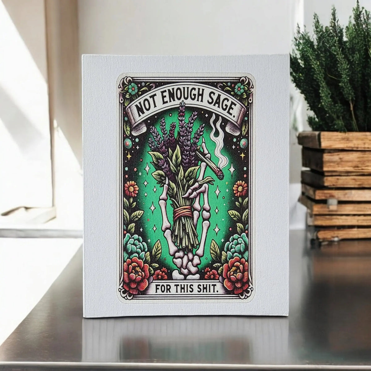 The Not Enough Sage Canvas Print by Mirabilia Boutique features a skeleton hand with sage and lavender, whimsical smoke, and colorful flowers. This 8x10 dark humor wall art adds witchy, sarcastic flair to your space with the quote “Not enough sage for this shit.”.
