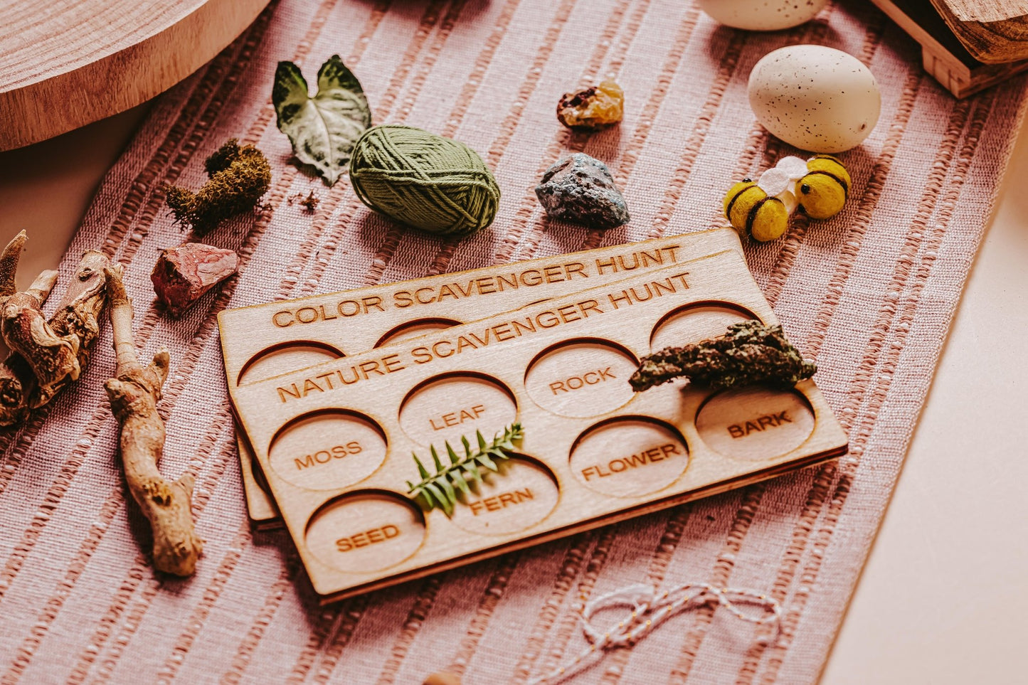The Mirabilia Boutique Outdoor Scavenger Hunt Bundle for Kids features Montessori nature and color wooden boards, with labeled spots for moss, leaf, rock, seed, fern, flower, and bark—perfect for screen-free exploration and learning.