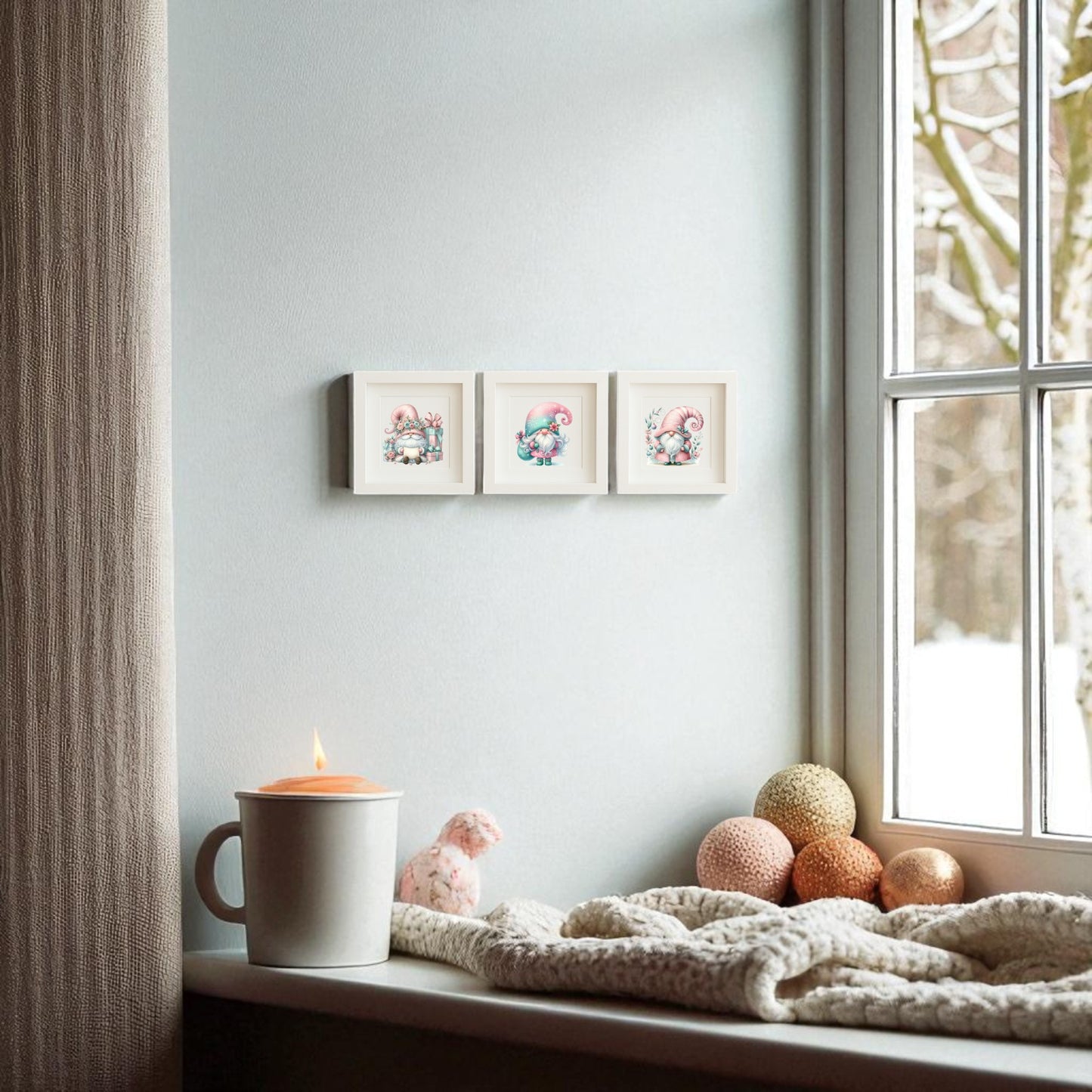 A cozy windowsill with a lit candle, knitted blanket, pink bunny plush, and decorative balls. Three “Pastel Gnome Wall Art Trio” prints by Mirabilia Boutique hang on the light wall. Snowy trees can be seen through the window.