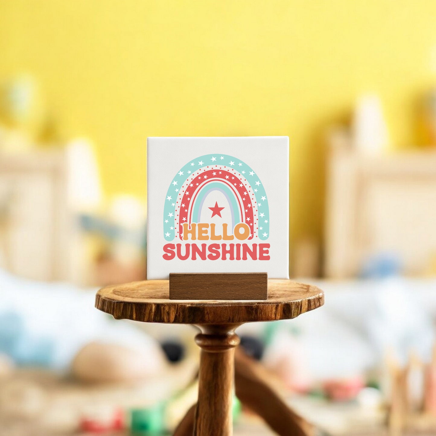 The Mirabilia Boutique Hello Sunshine Mini Canvas Sign with Stand features a rainbow and star design plus the phrase "Hello Sunshine," perfect as cheerful rainbow decor.