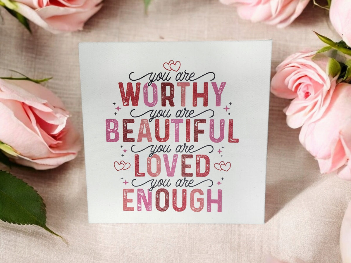 The Mirabilia Boutique You Are Worthy Affirmation Sign is an 8x8 inspirational canvas wall art featuring “You are worthy, you are beautiful, you are loved, you are enough” in pink and red fonts among pink roses—an uplifting decor or gift.