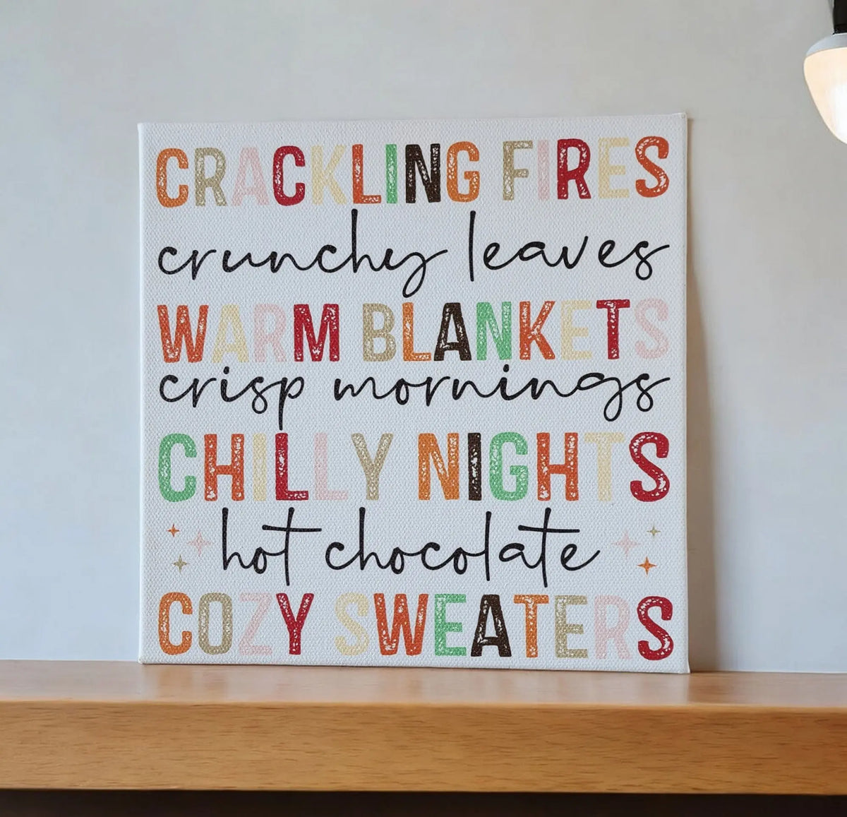 The Mirabilia Boutique Fall Words Canvas Sign, an 8x8 cradled wood canvas with UV printed autumn phrases like "crackling fires" and "cozy sweaters," brings cozy seasonal decor to your space.