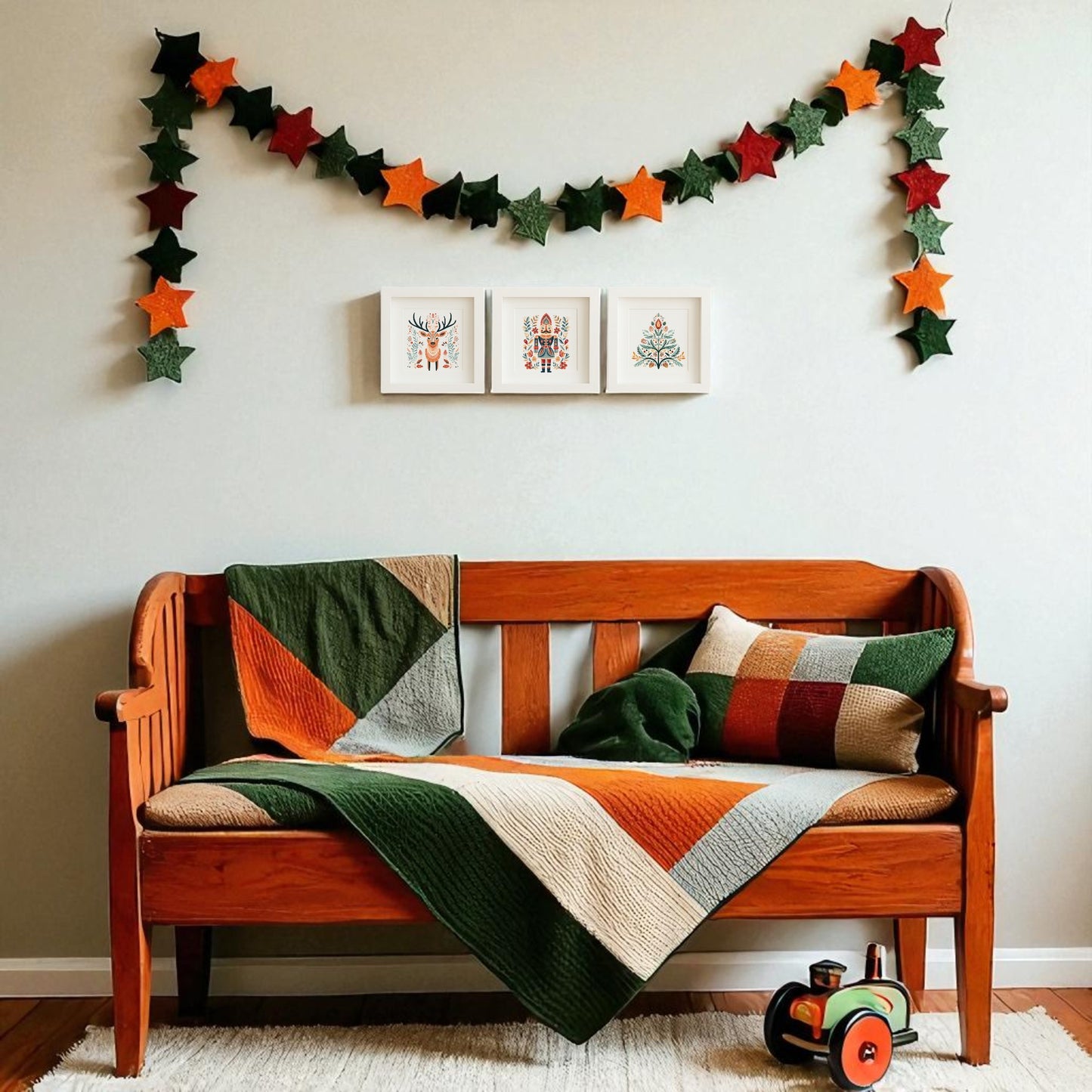 A wooden bench with a patchwork blanket and pillow sits on a rug. Above, three Mirabilia Boutique Reindeer Nutcracker Tree Shadowbox Trio prints bring festive Scandinavian style, while a wooden toy train rests on the floor.